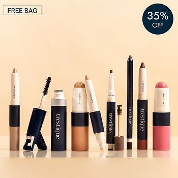 Trestique refillable makeup set featuring foundation, blush, lipstick, mascara, eyeshadow, eyeliner, brow pencil, and highlighter in sleek navy and neutral packaging. Displayed on a reflective surface with a beige background. Includes a 'FREE BAG' offer and a '35% OFF' discount badge.