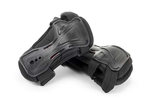 The SFR Double Splint Skate Protection Wrist Guards in black are designed by SFR to provide superior safety during activities like skating or skateboarding. Featuring ergonomic palm caps and double splints for enhanced stability and support, these wrist guards include adjustable straps and are set against a plain white background.