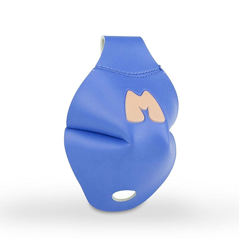 A periwinkle, playful object resembling a three-dimensional sculpture with a stylized 'M' on it, reminiscent of Moxi Skates. The object has a smooth, padded texture and an abstract shape, placed against a plain white background.