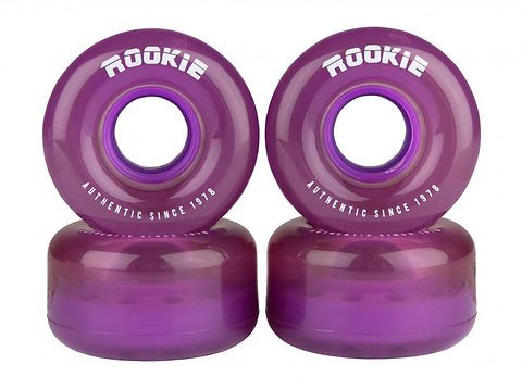 Four clear purple quad skate wheels from Rookie, measuring 58mm in diameter and 32mm in width, are stacked in pairs. They feature the brand name "ROOKIE" and the phrase "AUTHENTIC SINCE 1978" printed in white. These wheels have a smooth, glossy finish with a central hole for mounting, making them ideal for both indoor and outdoor skating.