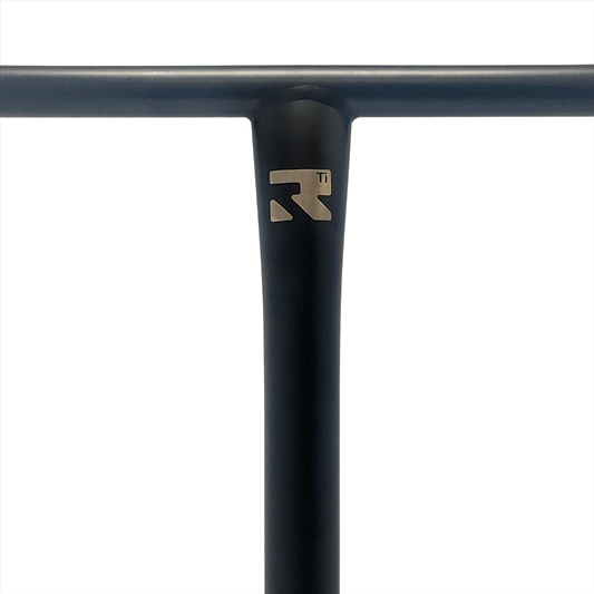 Close-up of a black T-shaped scooter handlebar with a metallic logo near the joint. The Root Industries AIR Titanium Oversized HIC Stunt Scooter T-Bars in Black (690mm x 600mm) feature a sleek and minimalist design, showcasing one of the strongest titanium constructions available, set against a plain white background for emphasis.