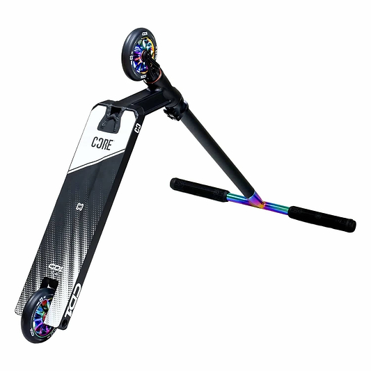 The CORE CD1 Complete Stunt Scooter, in a striking neochrome and black color scheme, features a durable aluminum deck and vibrant wheel hubs along with a colorful handlebar. The brand "CORE" is prominently displayed on the deck, making it ideal for beginner riders. It's showcased on one wheel to highlight its sleek frame design.