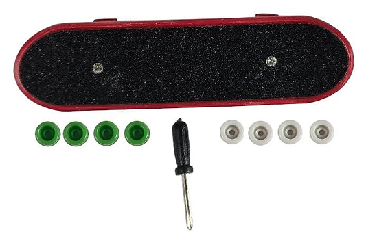 Displayed is a Finger Skateboard Toy in red and black grip tape from Skates.co.uk. Accompanied by a small screwdriver, it comes with four green and four white wheels arranged beneath it, ideal for fingerboarding enthusiasts or mini skateboarders.