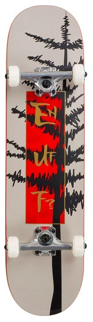 The Enuff Evergreen Tree Warm Grey / Red Complete Skateboard (8" x 32") features a 7-ply maple deck with black tree silhouettes, abstract yellow symbols on a red panel, white wheels, and sturdy metal trucks.