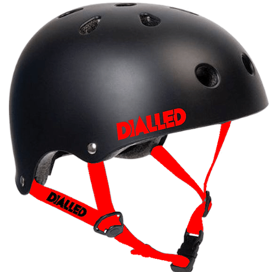 The Dialled Protection Adjustable Skate / Scooter Helmet in black and red has a durable ABS shell with numerous ventilation holes and adjustable red straps for the ideal fit. The brand name "DIALLED" is prominently displayed in red on the side of the helmet and the strap.