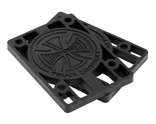 A pair of Independent Skateboard Riser Pads (1/8") in black, complete with the iconic Indy trucks logo embossed on them. These custom-molded risers feature a circular design in the center and multiple holes for easy mounting.