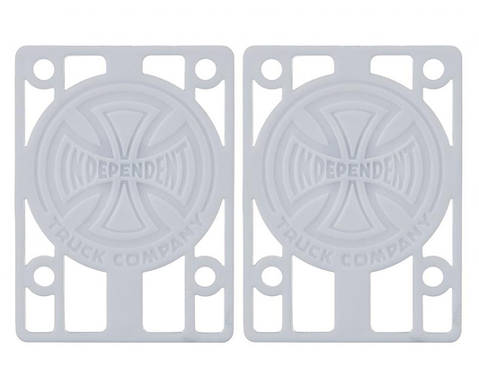 A pair of white skateboard risers featuring the "Independent Truck Company" logo with a cross design. The Independent Skateboard Riser Pads, measuring 1/8", have multiple slots for mounting and are perfectly compatible with Indy trucks.
