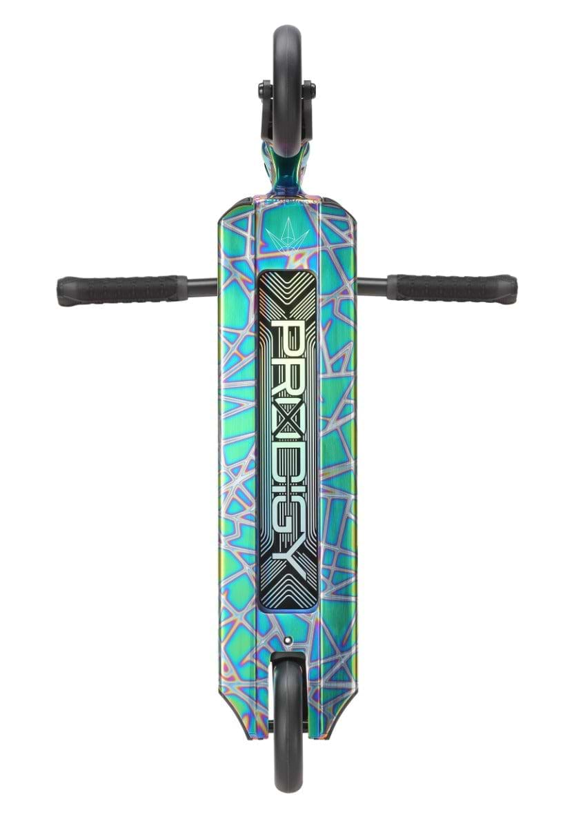 An overhead shot reveals the vibrant Blunt Envy Prodigy X Complete Stunt Scooter in Oil Slick Neochrome, featuring a geometric pattern and the "PRODIGY X" branding on its deck. This scooter comes complete with two black handles extending outward and showcases wheels designed with Extech extrusion for increased durability.