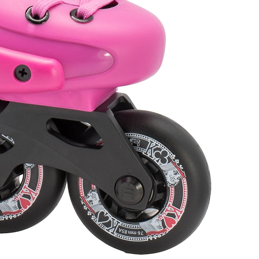 Close-up of the FR Skates Junior Adjustable Inline Skates - Pink, showcasing extruded aluminum X-Series frames and black wheels. The decorative white and red patterns feature card suits like hearts and spades. The pink boot, ideal for freeriders, is partially visible with pink laces.