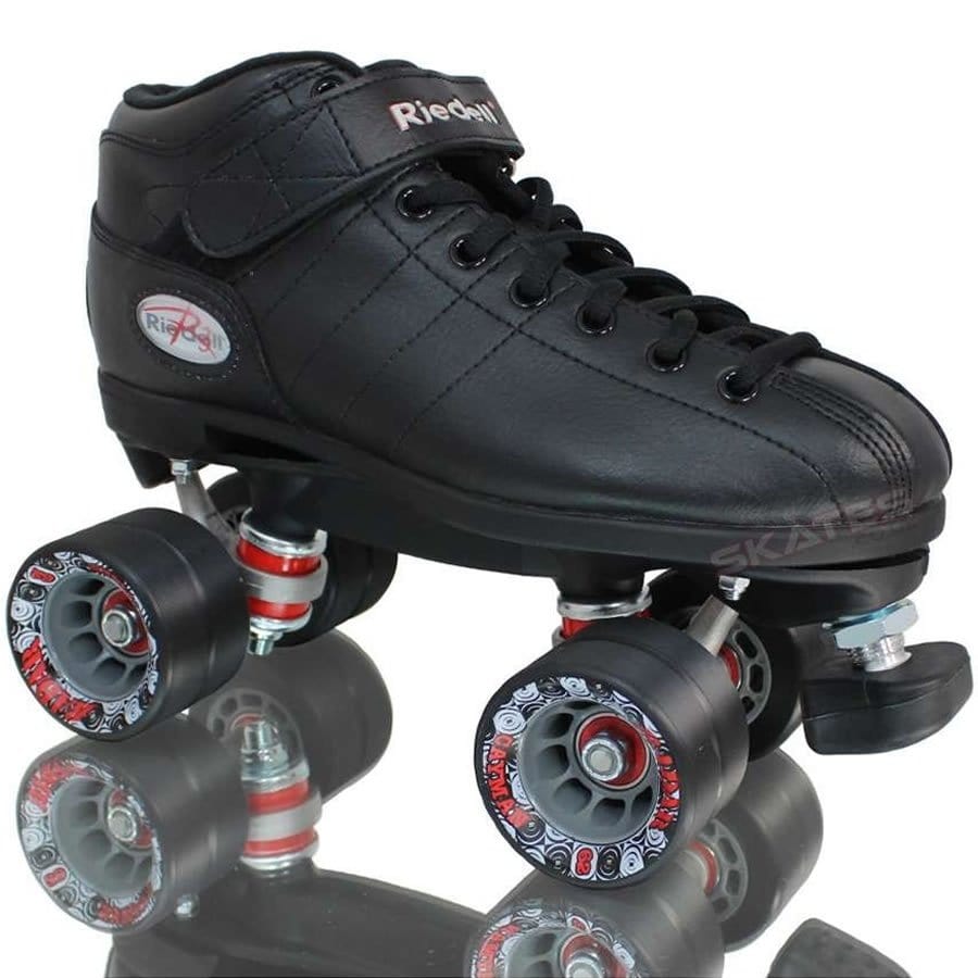 The Riedell R3 Roller Derby Quad Skates in black feature a sleek low-top boot design, complete with PowerDyne Thrust Nylon Plates. They come with four Radar Cayman wheels adorned with red and gray patterns and a front brake stopper, elegantly displayed on a reflective surface.