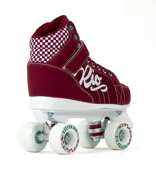 The red Rio Roller Mayhem II Quad Roller Skates feature a checkered ankle cuff, white sole, and four white wheels. With teal eyelets and a sporty design, these roller derby-style skates are built with a Hi-Impact Chassis for top-level performance. The side displays "Rio" in bold white script.