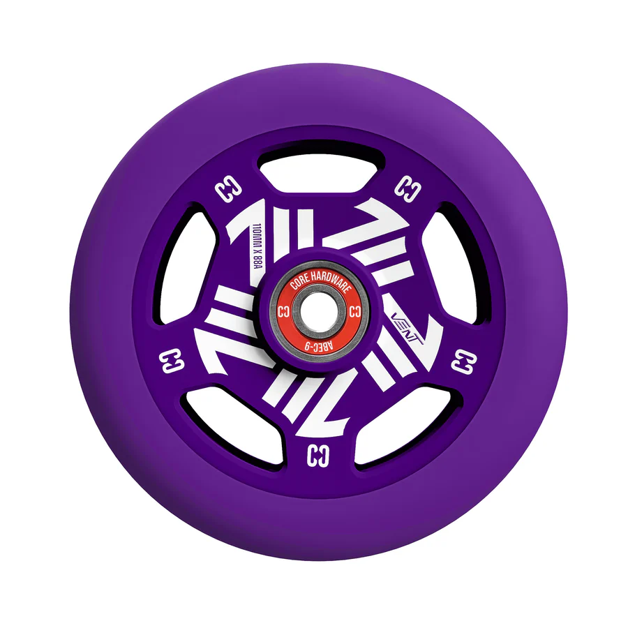 A close-up of the CORE Vent 110mm Stunt Scooter Wheel in purple, featuring white geometric designs, black cutouts, and a red core labeled "CORE HARDWARE C3" and "ABEC-9," capturing the signature style of CORE wheels.