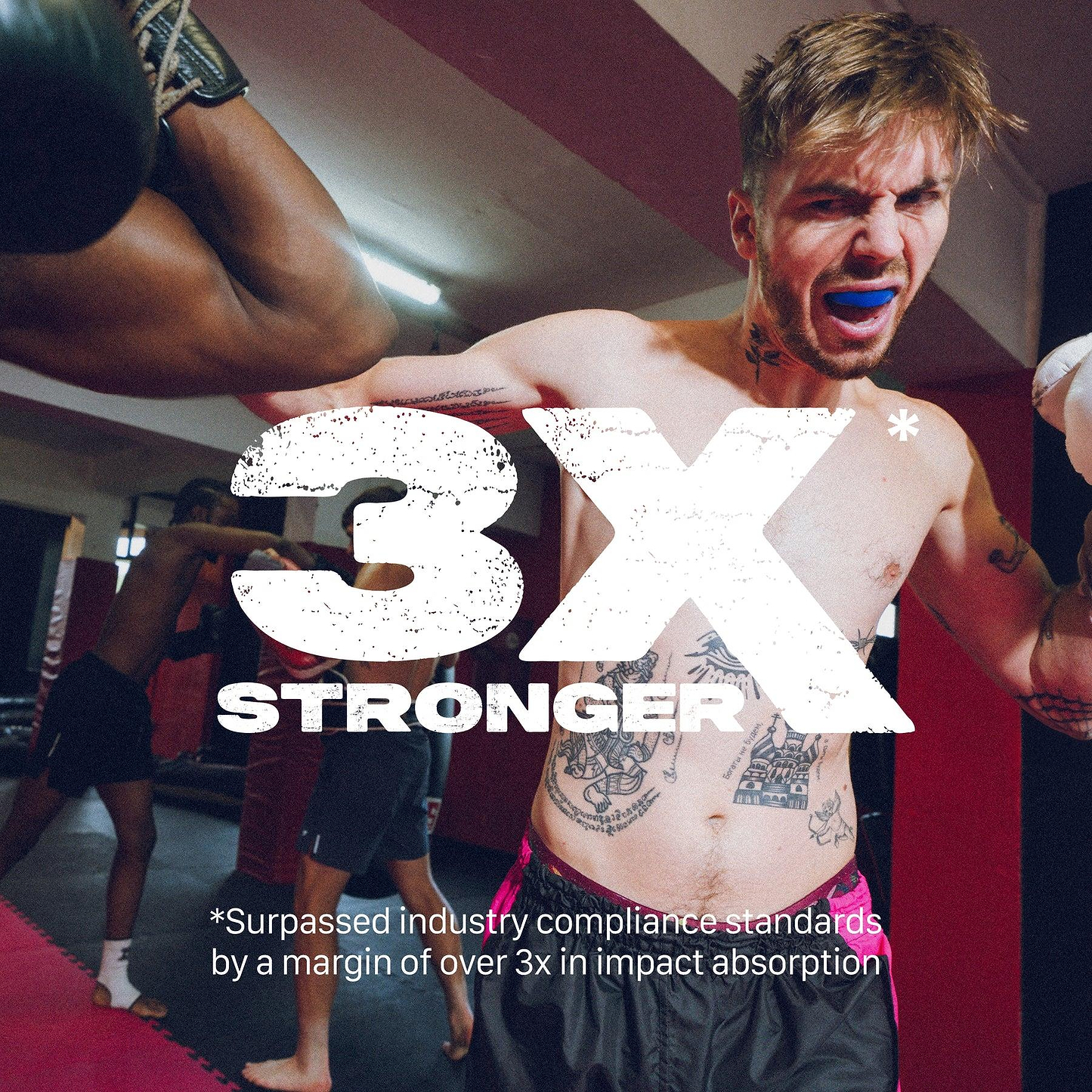 A tattooed male boxer wearing a blue Safejawz Intro Series Protection Mouthguard blocks a punch in the gym. Bold text: “3X STRONGER.” Caption notes Safejawz delivers jaw stability, absorbing over 3x the industry standard impact.