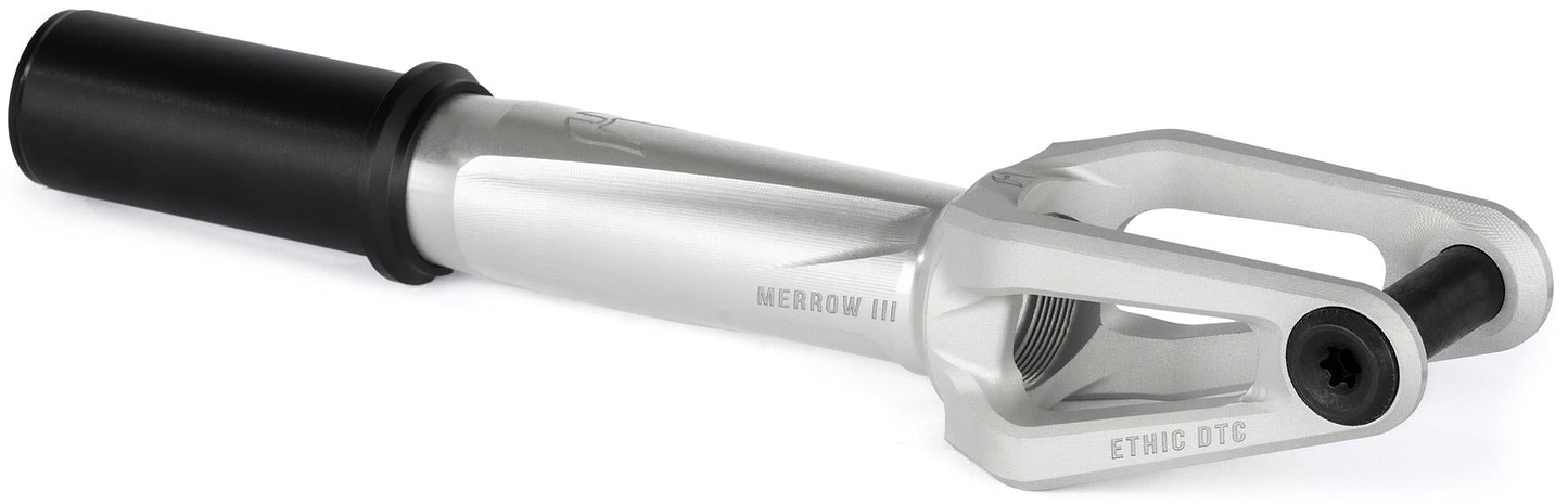 A raw Ethic DTC Merrow V3 8/12STD IHC stunt scooter fork by Ethic features a black cylindrical spacer and "MERROW III" and "ETHIC DTC" labels, designed for mounting 12STD scooter wheels.