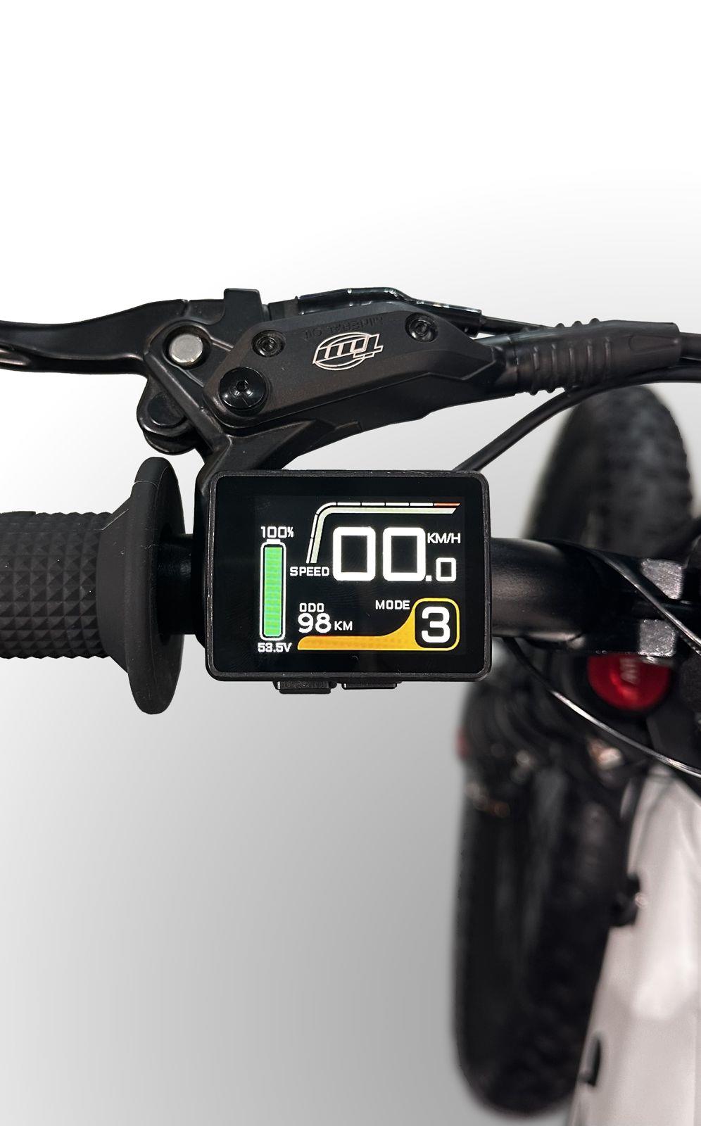 Close-up of the Duo 18" Blitz Kids Electric Balance Bike's digital display showing 100% battery, 0 km/h speed, 98.0 km distance, 53.5V voltage, and mode 3. Handlebar grip and brake lever of this Duo bike are also visible.