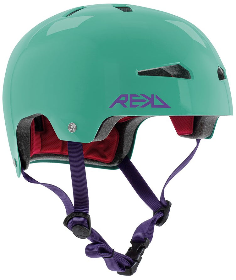 The REKD Elite 2.0 Skate / Scooter Helmet in gloss teal features a purple REKD logo, dark purple adjustable straps, and red interior padding. Lightweight, certified, and comfortable—perfect for safe cycling or skating adventures.