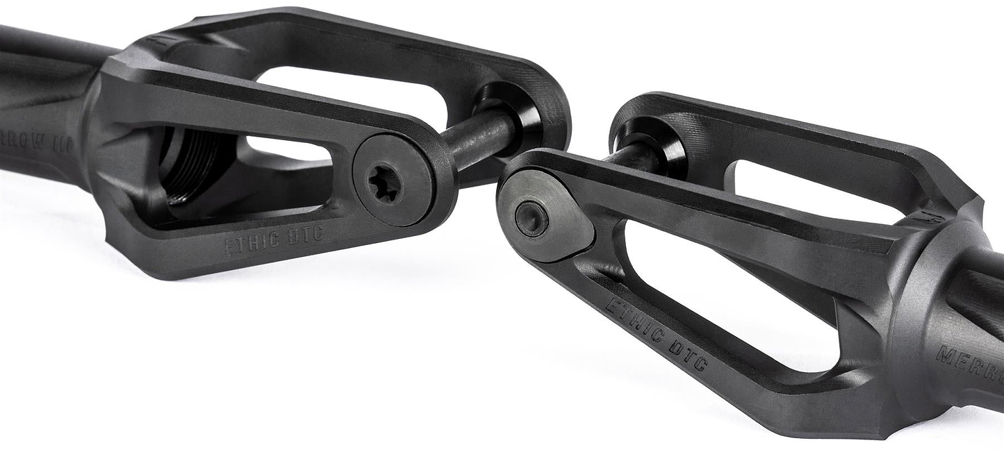 Close-up of two Ethic DTC Merrow V3 8/12STD SCS Stunt Scooter Forks in black, featuring open triangular designs and central bolts, positioned facing each other against a white background.