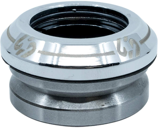 A close-up of the CORE Icon Integrated Stunt Scooter Headset - Chrome by CORE, showcasing its shiny metallic finish, engraved details, circular design, and visible black inner rings and grooves.