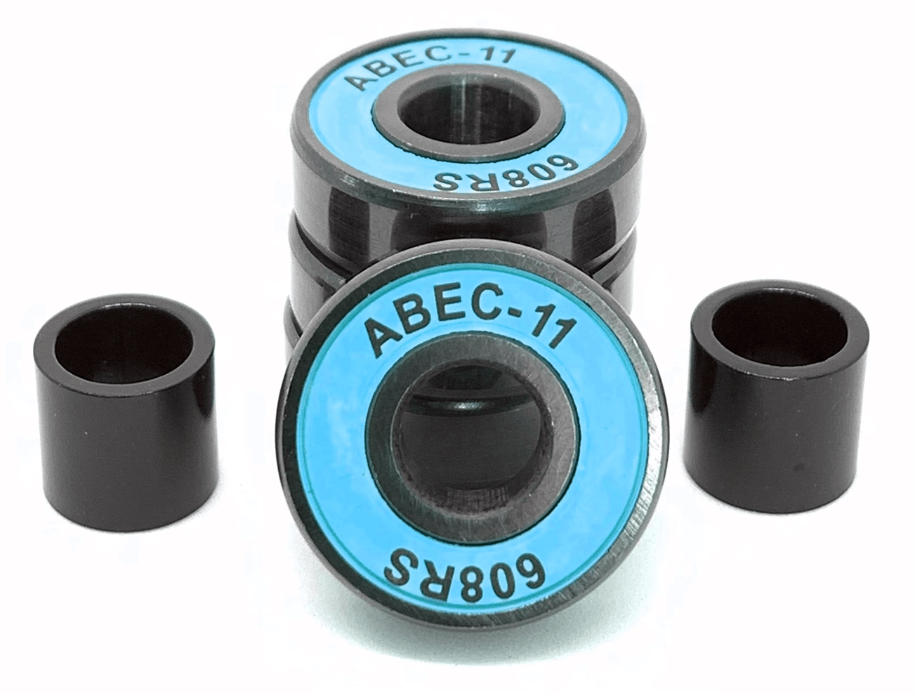 Close-up of four Logic ABEC 11 Blue Scooter Bearings from Logic. Two black cylindrical spacers are positioned next to the bearings. These premium quality performance speed bearings feature a blue and black design with visible inner and outer rings, making them ideal for skateboards and scooters alike.