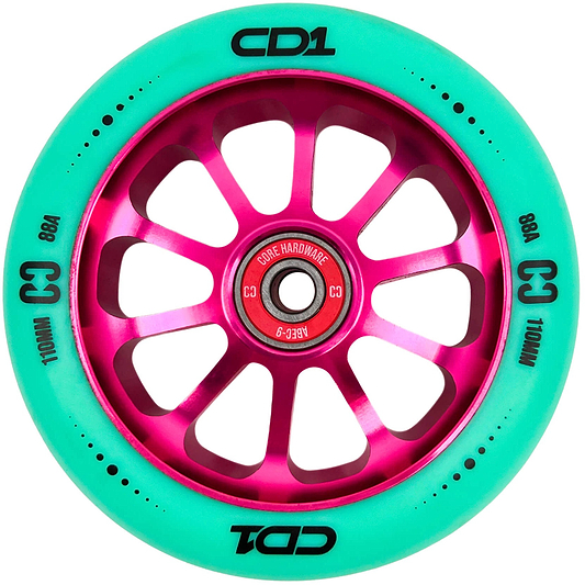The CORE CD1 110mm Stunt Scooter Wheel - Teal / Pink features a metallic pink multi-spoke hub and teal rubber with “CD1,” “C3,” “88A,” and “110MM” in black. The bearing is visible at the center. Brand: CORE.