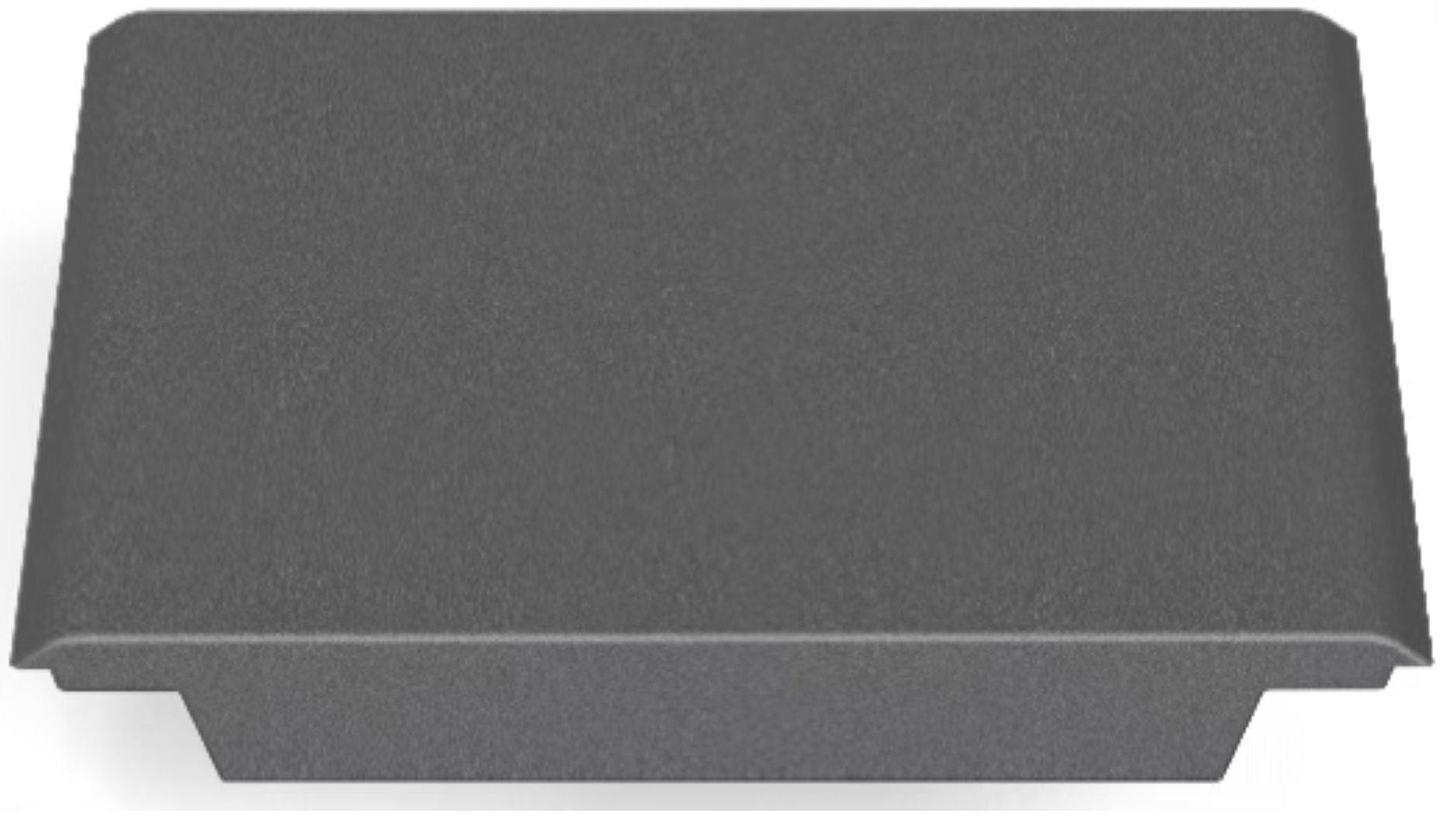 A gray, rectangular plastic cover with a smooth, slightly raised top and flared edges, resembling the CORE Mini Funbox Ramp Set – 2 Kickers & Flat Deck by CORE, viewed from an angle showing both the top and one side.