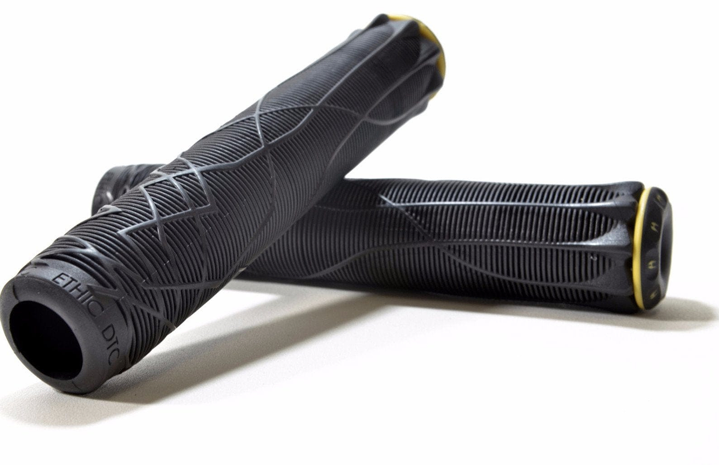 Two Ethic black stunt scooter grips, each measuring 170mm and made from durable thermoplastic rubber, showcase textured patterns with yellow accents. They are arranged overlapping on a white background.