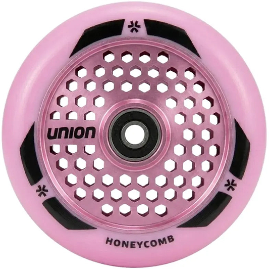 The Union Honeycomb Pro 110mm Stunt Scooter Wheel in pink features a honeycomb-patterned hollowcore metal design with black accents and "UNION" and "HONEYCOMB" printed on it.