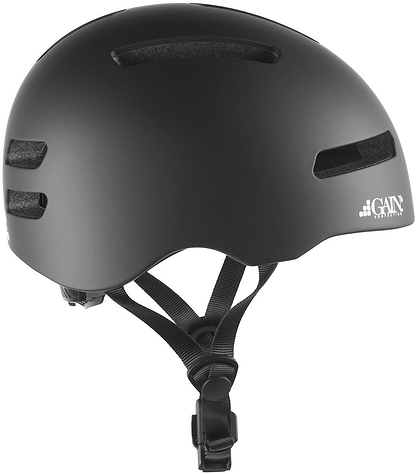 The GAIN Protection The Edge Pro Skate / Scooter Helmet in black features ventilation slits, adjustable straps, featherlight in-mould technology, a Fidlock magnetic buckle, and the GAIN Protection logo on the lower right side.