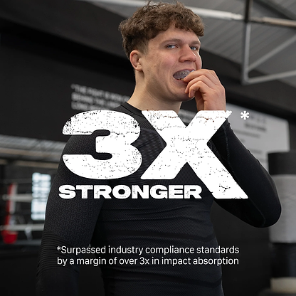 A young man in athletic wear bites into the Safejawz Intro Series Protection Mouthguard - Clear at the gym, showing its comfortable fit. Large text reads "3X STRONGER." Below: "Surpassed industry standards by 3x in impact absorption.