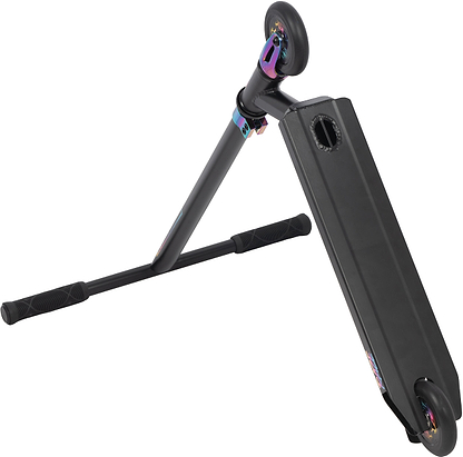 The Legacy Raze Complete Stunt Scooter by Legacy is displayed at an angle, showcasing its black handlebars, deck, oil slick accents, and two small wheels. The entry-level scooter is tilted to reveal its underside and handle grips.