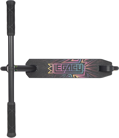 Top view of the Legacy Raze Complete Stunt Scooter by Legacy, featuring a textured foot deck with colorful "LEGACY" text and geometric patterns. The black/oil slick kids stunt scooter has a T-shaped handlebar with comfy rubber grips.