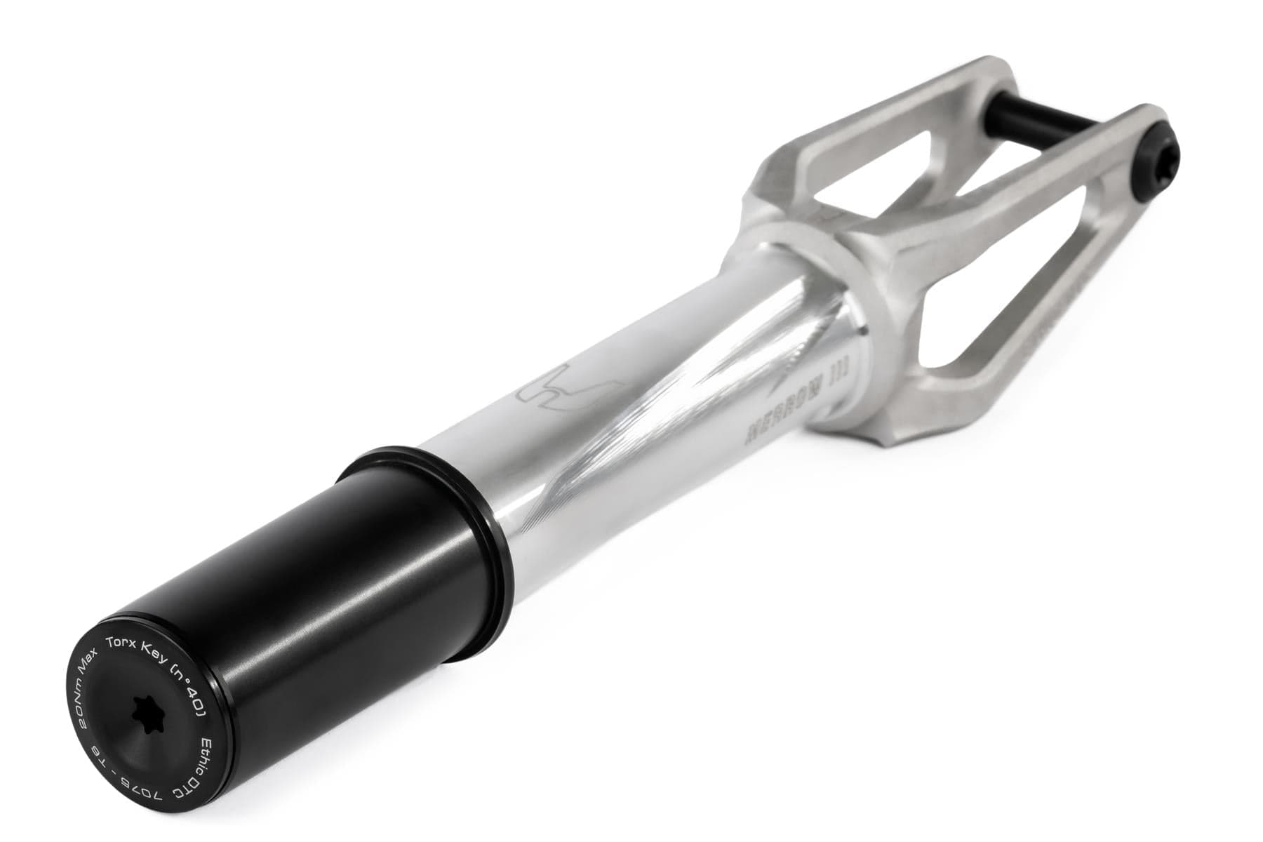 The Ethic DTC Merrow V3 HIC Stunt Scooter Fork in Raw Silver, made by Ethic from 7075 aluminium, features a black axle cap, open geometric frame, cylindrical section, and is designed to be the lightest fork in the world.