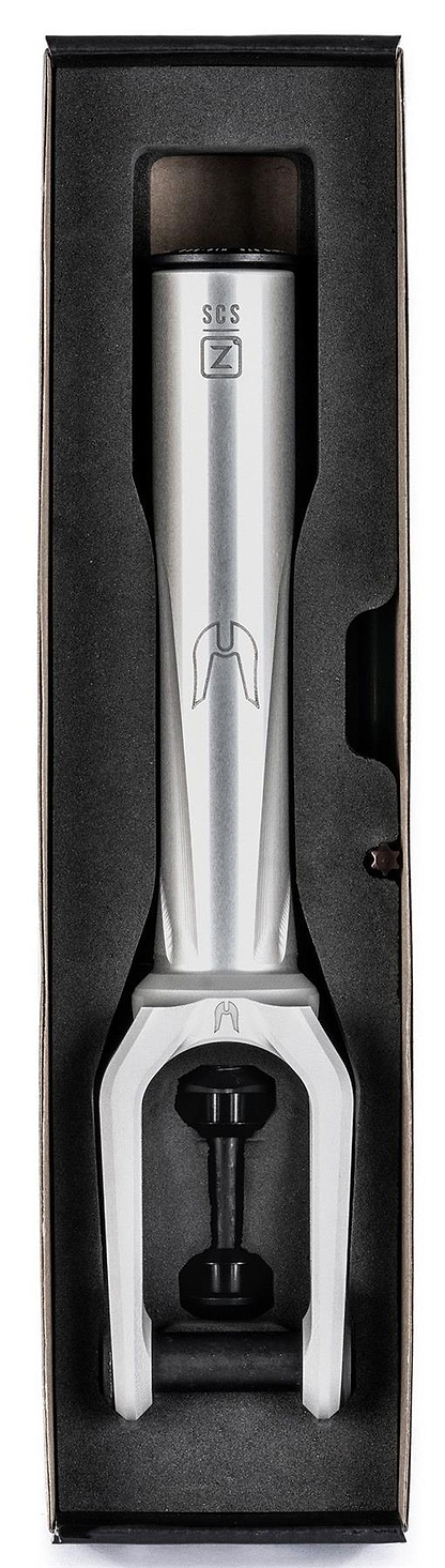A raw Ethic DTC Merrow V3 8/12STD SCS stunt scooter fork by Ethic, featuring “M” and “SCS” logos, is shown from above in a black foam box with fitted compartments.
