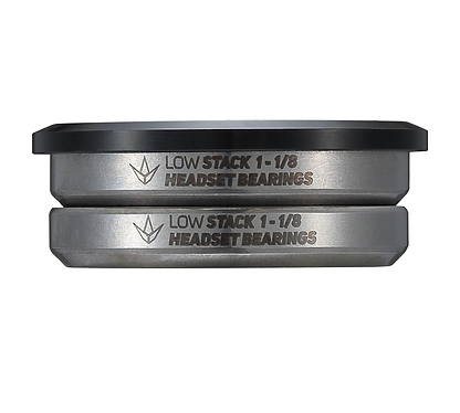 A close-up of two metallic bearings stacked together, ideal for a stunt scooter headset. The sides are engraved with "Blunt Envy Low Stack IHC Integrated Stunt Scooter Headset - Black," showcasing the Blunt Envy logo above. The top bearing features a sleek black outer edge.