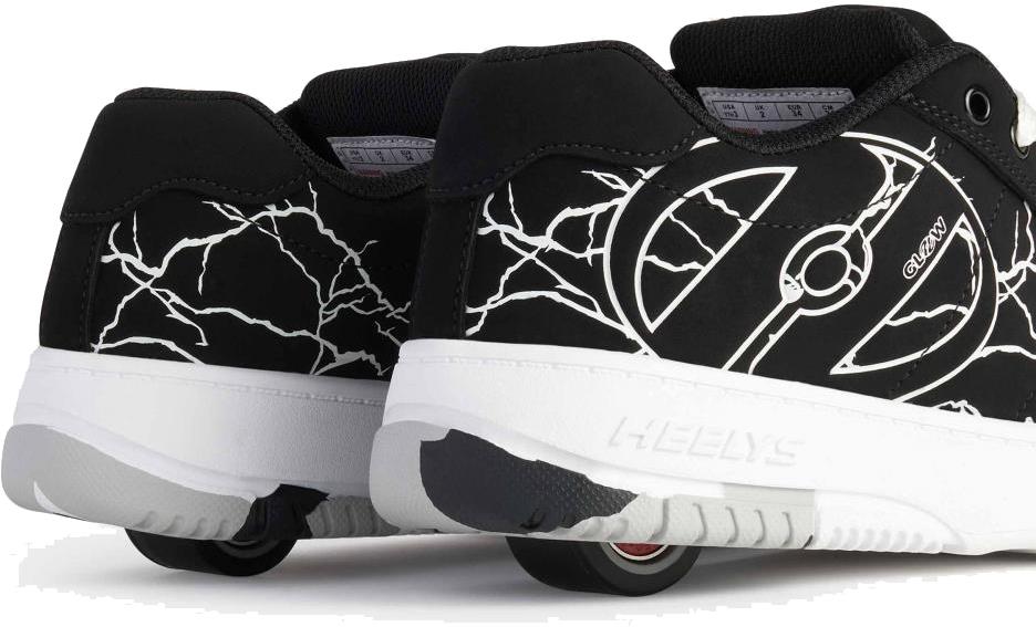 A close-up of Heelys Kolect Glow Boys Shoes in Black/White by Heelys, showcasing white crackle patterns and built-in wheels with ABEC 5 bearings, viewed from the back and side.