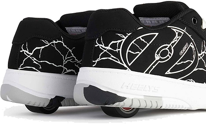 A close-up of Heelys Kolect Glow Boys Shoes in Black/White by Heelys, showcasing white crackle patterns and built-in wheels with ABEC 5 bearings, viewed from the back and side.