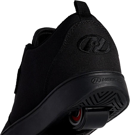 Close-up of Heelys Pro 20 Boys Shoes - Triple Black Canvas viewed from the back, showing the wheel in the sole and Heelys logo on the side and back.