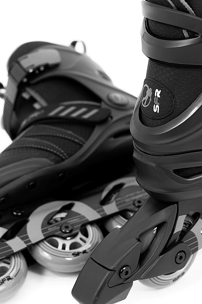 Close-up of SFR Venture Pro Inline Skates - Black by SFR, showcasing sleek black design with silver accents. The wheels feature ABEC-7 bearings and an aluminum frame, aligned with branded details, for a dynamic and sporty look.