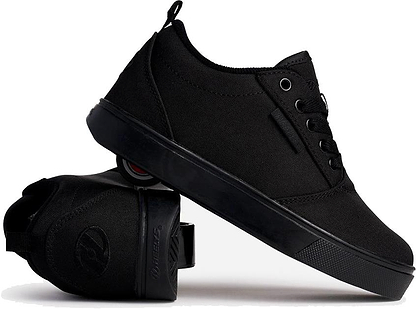 A pair of Heelys Pro 20 Boys Shoes in Triple Black Canvas, one upright and one tilted to show the retractable wheel—ideal for skating just like classic Heelys.