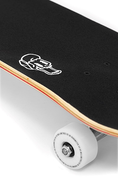 A close-up of the Enuff Meltworld Mini Dazed Complete Skateboard (7.25" x 29.5") shows white wheels, black grip tape, and a bold deck graphic—perfect for young riders looking for their first Enuff skateboard.