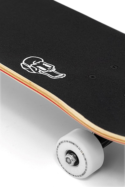Close-up of the Enuff Pyro III Blue Complete Skateboard (7.75" x 31.5") by Enuff, showing its 7-ply maple deck with black grip tape, white skull-with-cap graphic, visible wooden edge, and one white wheel against a plain background.