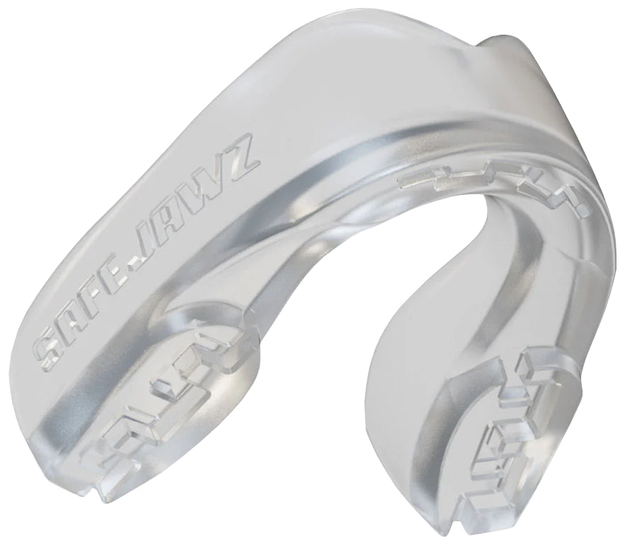The Safejawz Intro Series Protection Mouthguard - Clear by Safejawz offers jaw stability, protects teeth during sports, and ensures a comfortable fit. The clear design features "SAFEJAWZ" embossed on the side.