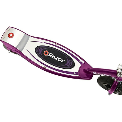 Close-up of the Razor E100 Kids 24V Electric Scooter in purple, featuring a black and white deck design with the Razor logo. The back wheel and part of the front wheel are visible on this popular Razor kids scooter.