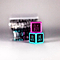 Two vibrant dice from the Trick Dice Beginner Scooter Set are stacked, featuring a top pink die that reads "Fly Out" and a bottom blue die displaying "No Footer" and "One Hander." This Trick Dice challenge is perfect for any pro rider ready to take on daring dice tricks with blurred backdrops of similar dice in anticipation.