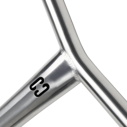 Close-up of the CORE Apollo Titanium HIC Oversized Stunt Scooter Bars (Raw, 630mm x 610mm) showing a metallic Y-shaped joint with smooth welds and a black "C3" logo on the polished titanium surface.