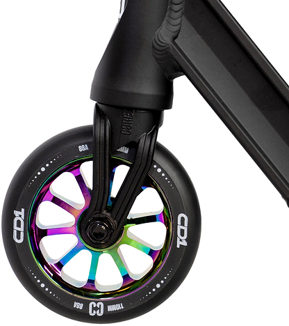 Close-up of a CORE CD1 Complete Stunt Scooter (Neochrome/Black) front wheel by CORE, featuring a metallic rainbow core, black tire, bold white lettering, and attached to a sleek black fork and deck.