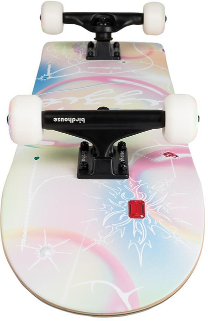 A close-up of the Birdhouse Stage 3 Armanto Bubbles Complete Skateboard (8" x 31.5") by Birdhouse, featuring white wheels, black trucks, and a pastel deck with abstract dreamy designs in soft pink, blue, yellow, white line art, and a red gem graphic.