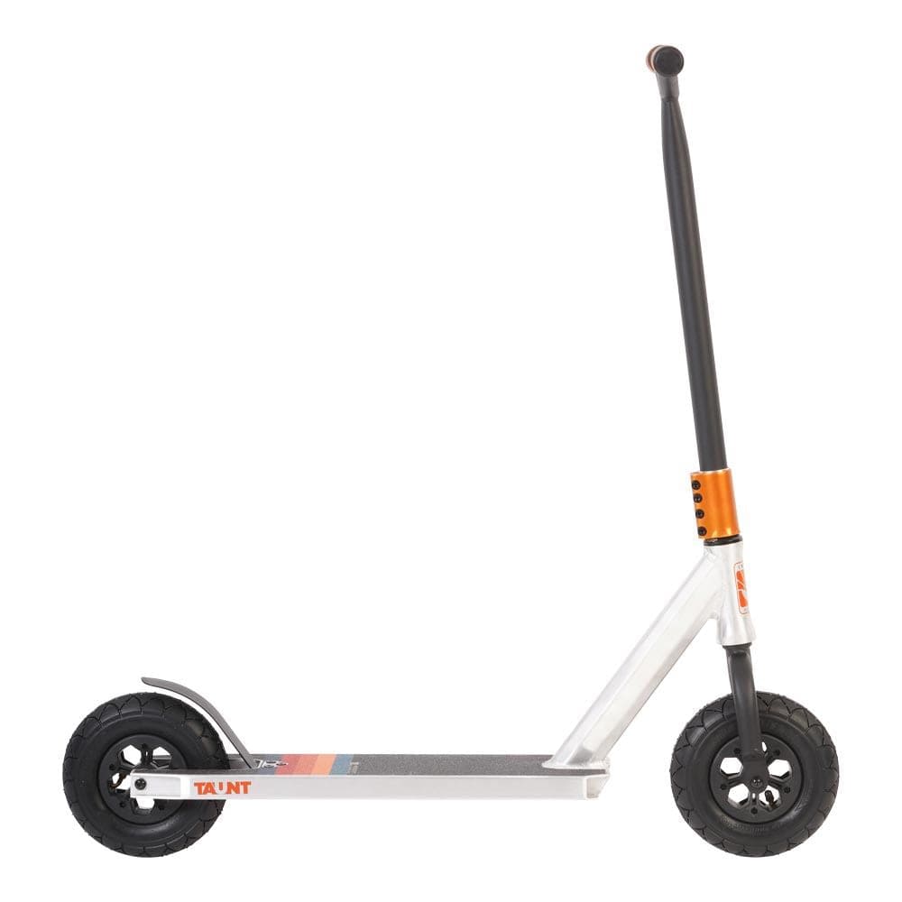 The Invert Supreme Taunt Dirt Scooter in Raw/Orange/Green showcases a silver design with black wheels and a sleek black handlebar, accentuated by an orange detail near the handlebar stem and featuring the brand's logo on the deck. This stylish scooter also includes an integrated headset for smooth riding.