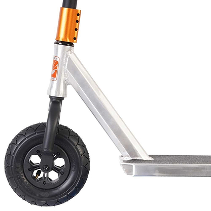 Close-up of the Invert Supreme Taunt Dirt Scooter's front wheel and deck. The pneumatic wheel features a black tire with a five-spoke design, while the deck is metallic with an orange accent on the handlebar stem. The frame is lightweight and metallic, boasting an integrated headset for smooth rides.
