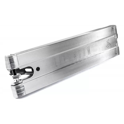 Close-up of the Ethic DTC Lindworm V4 Raw Silver Stunt Scooter Deck, measuring 5.9" x 21.25", with "Lindworm V4" engraved on its side. It boasts sleek, angular lines and visible bolt attachments, showcasing a sturdy and modern design that's perfect for urban street adventures.